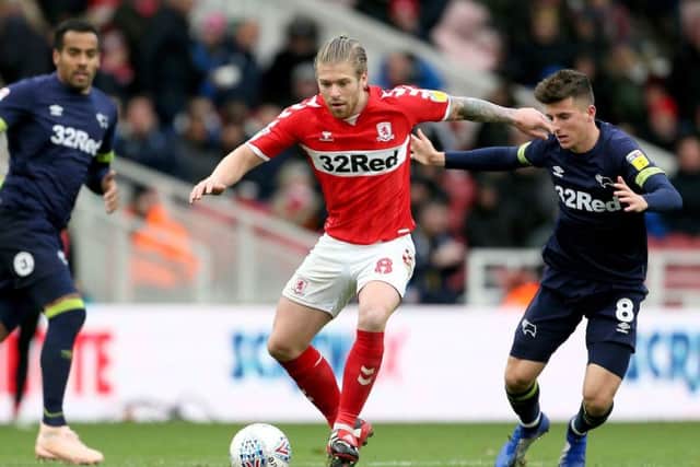 Middlesbrough's Adam Clayton and Derby County's Mason Mount (right) battle for the ball at The Riverside Stadium. Picture: Richard Sellers/PA