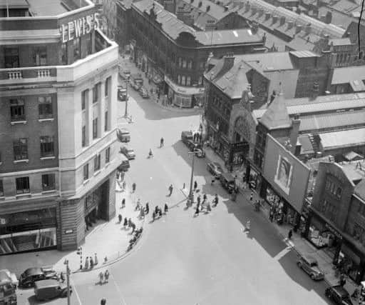Leeds, 1950-1959. 
Rooftop view of the Headrow with Lewis's shop in the foreground, left and Schofields on the right. Possibly from 1953, as there is a prominent picture of Queen Elizabeth II in front of Schofield's department store.