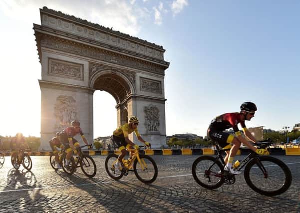 Competititors cycle past the iconic Arc de Triomphe in Paris on the last day of racing on Sunday. Picture: PA.