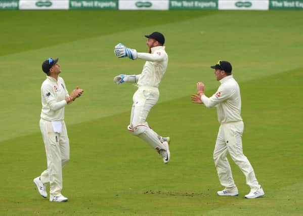 England wicketkeeper Jonny Bairstow (c) celebrates with Joe Root and Jason Roy after catching William Porterfield during day three of the test and Ireland at Lord's. Picture: Stu Forster/Getty Images