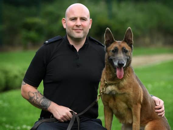 West Yorkshire Police dog handler PC David Lowry with police dog Resi.