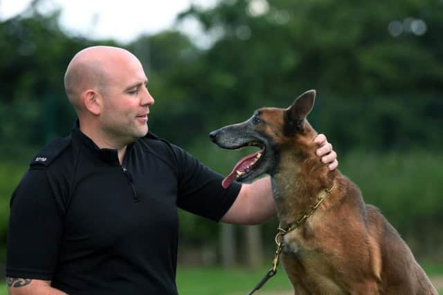 West Yorkshire Police dog handler PC David Lowry with police dog Resi.