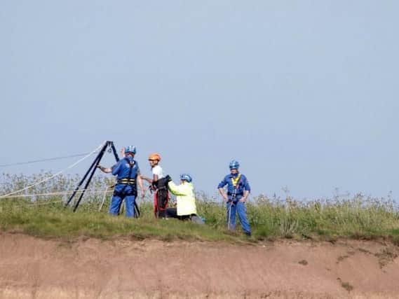 Coastguard crew rescuing a man and a woman from Filey Brigg in North Yorkshire (Photo: Owen Scrimshaw/PA Wire)