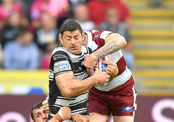 END OF THE LINE: Hull FC's Mark Minichiello is tackled by Wigan Warriors' Sam Tomkins. Picture: Dave Howarth/PA