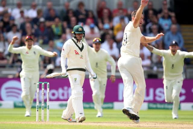 Reviewed: Australia's Usman Khawaja reacts before a review gives him out caught behind by Jonny Bairstow off Chris Woakes.