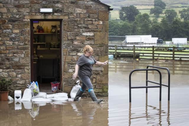 Flood water outside Dales Cafe and Cakery. Photo: Danny Lawson/PA Wire