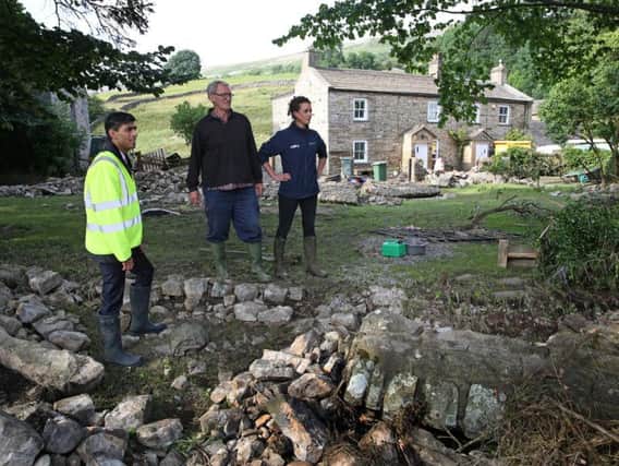 Richmond MP Rishi Sunak surveys the damage at a flood-hit farm in the Yorkshire Dales. Picture courtesy of the National Farmers' Union.