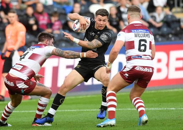 Hull's Jamie Shaul is tackled by Wigan's Oliver Gildart. (Picture: Jonathan Gawthorpe)