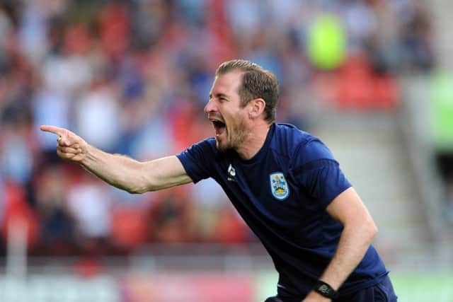 WAITING GAME: Huddersfield Town manager Jan Siewert leads his team into action at home to Derby County on Monday night. Picture: Tony Johnson.