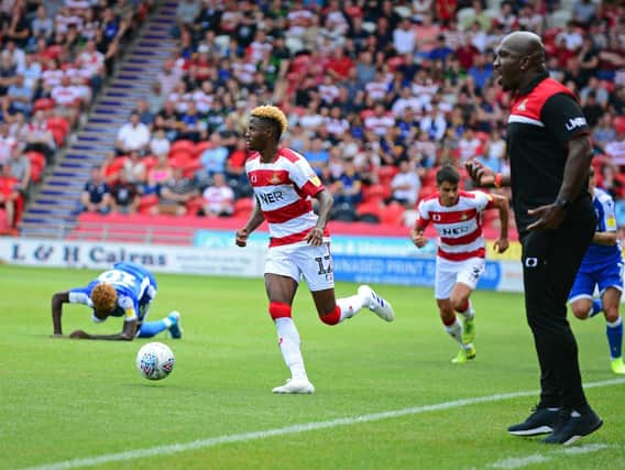 Darren Moore watches on as Madger Gomes gets on the ball
