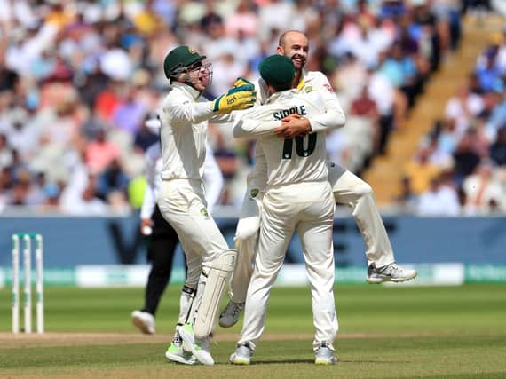 Key wicket: Australia celebrate the fall of England captain Joe Root.