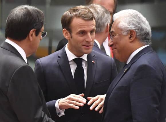 French President Emmanuel Macron, centre, speaks with Portuguese Prime Minister Antonio Costa, right, during a round table meeting at an EU summit in Brussels in November 2018. (AP Photo/Geert Vanden Wijngaert)