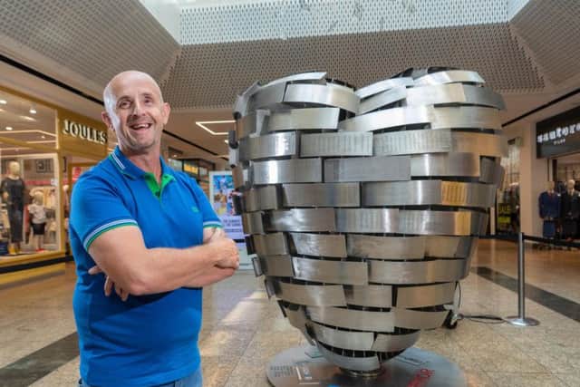 Tony Surgey, who suffered a heart tumour, is among those backing the British Heart Foundation's 'Heart of Steel' at Meadowhall Shopping Centre, each strand of the steel sculpture engraved with the names of hundreds who have been affected