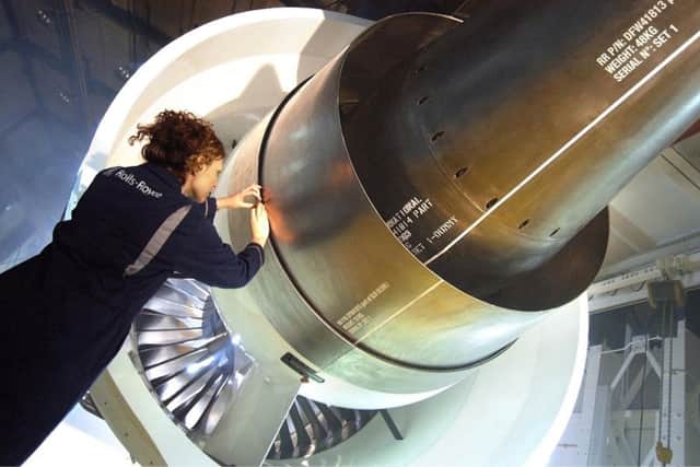 A worker inspects a Trent 1000 Aircraft engine at one of the Rolls Royce's plants.
