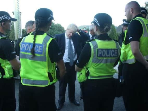Boris Johnson speaks to police officers in Whaley Bridge. Picture: PA