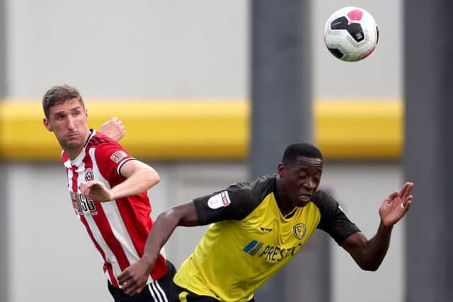 Sheffield United's Chris Basham (left) and Burton Albion's Lucas Akins battle for the ball in pre-season (Picture: PA)