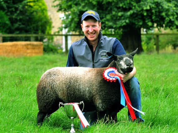 Mark Stephenson with his prizewinning Blue Texel Ewe Lamb at Nuburnholme Wold farm