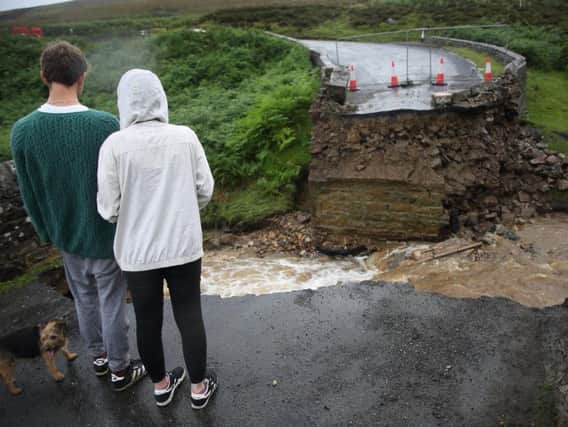 Two bridges were swept away in the Yorkshire Dales as "unprecedented" rainfall led to flash flooding