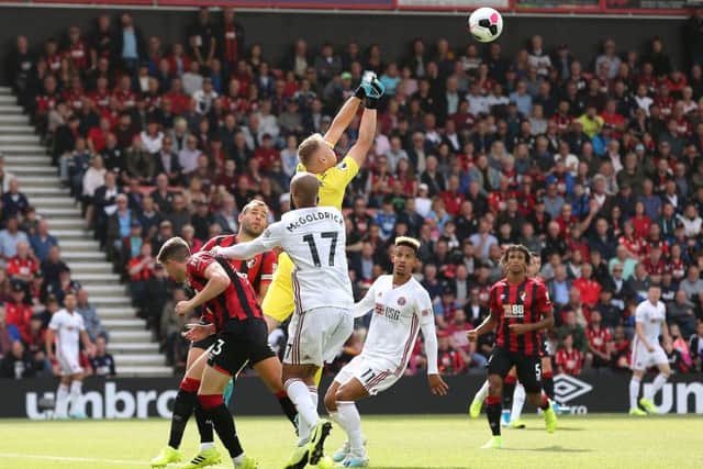 Bournemouth goalkeeper Aaron Ramsdale (centre) punches the ball away