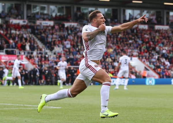 POINT TO PROVE: Billy Sharp wheels away after earning Sheffield United a 1-1 draw with his first Premier League goal. (Picture: Sportimage)