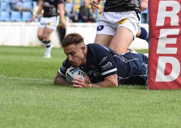 Cameron King touches the ball down for a try for Featherstone Rovers against Swinton Lions. Picture: Dec Hayes