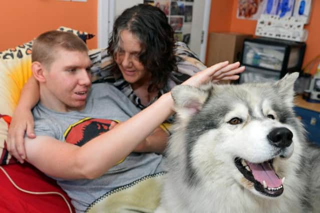 Ben Fyfield with his mother Liz Baldwin and Thunder the therapy dog.