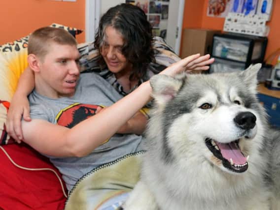Ben Fyfield with his mother Liz Baldwin and Thunder the therapy dog.