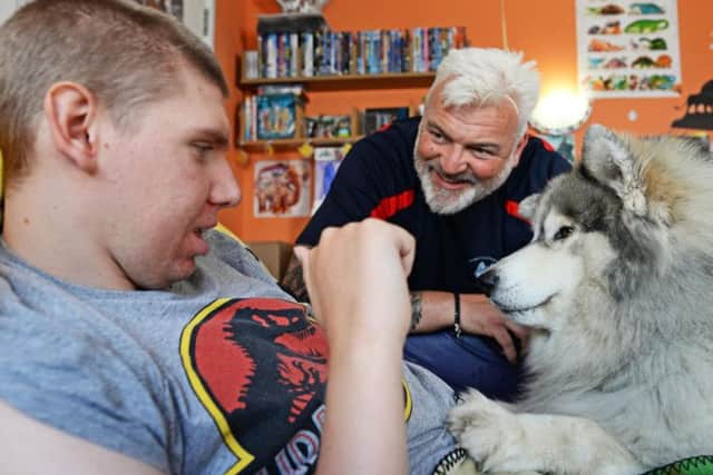 Ben and Thunder have established a heartwarming bond. They are pictured here with Adrian Ashworth, who runs Therapy Huskies.