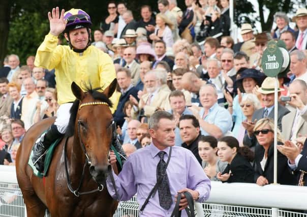 Salute: Sea The Stars and Mick Kinane return to the winner's enclosure after victory in the 2019 Juddmonte International at York.