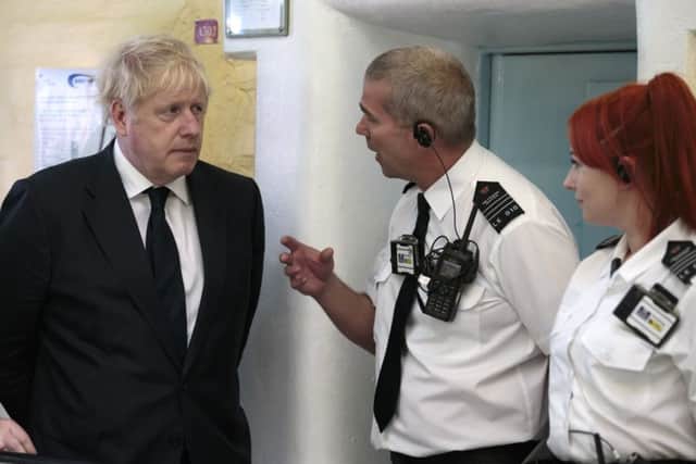 Boris Johnson talks to prison staff in Leeds.