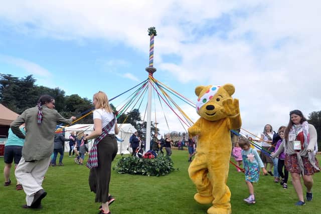 Pudsey Bear joins in with dancing around the maypole at Countryfile Live at Castle Howard near York. Picture by Tony Johnson.