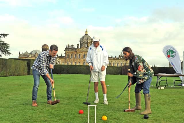 Countryfile presenters Matt Baker and Anita Rani play croquet on the lawns at Castle Howard in front of the stately home under the watch of Derek Knight from the Croquet Association. Picture by Tony Johnson.