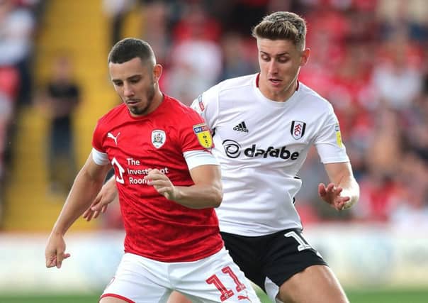 Fulham's Tom Cairney (right) and Barnsley's Conor Chaplin (left) battle for the ball.