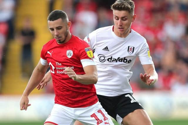 Fulham's Tom Cairney (right) and Barnsley's Conor Chaplin (left) battle for the ball.