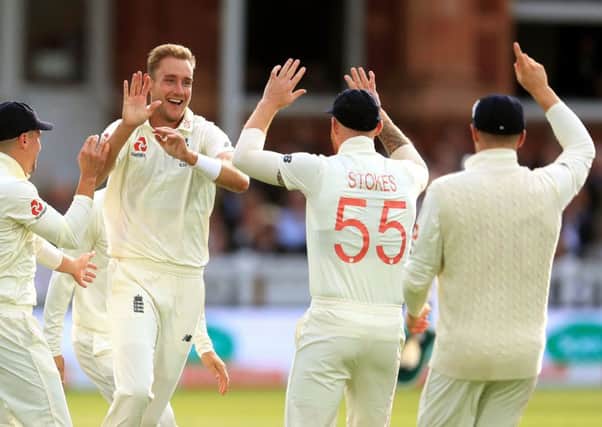 Englands Stuart Broad and team-mates celebrate taking the wicket of Australias David Warner at the end of day two of the Ashes Test match at Lords.