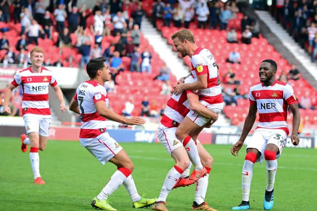 James Coppinger celebrates with team mates as Rovers find the winning goal in stoppage time against Fleetwood Town