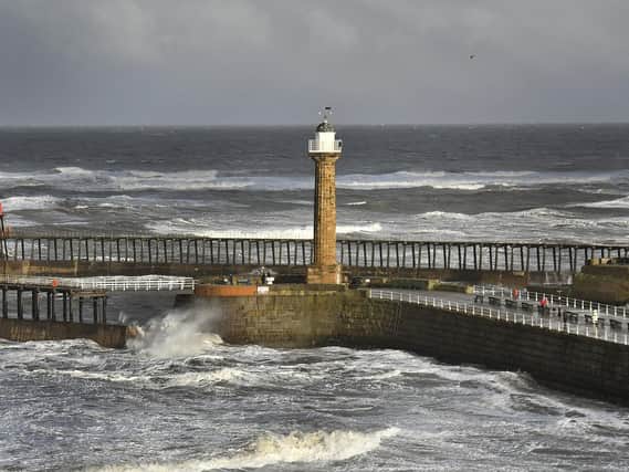 Whitby's Pier and Lighthouse take a battering in the the strong winter winds