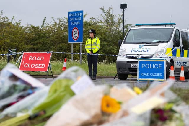 Floral tributes have been left at the scene where PC Andrew Harper was murdered.