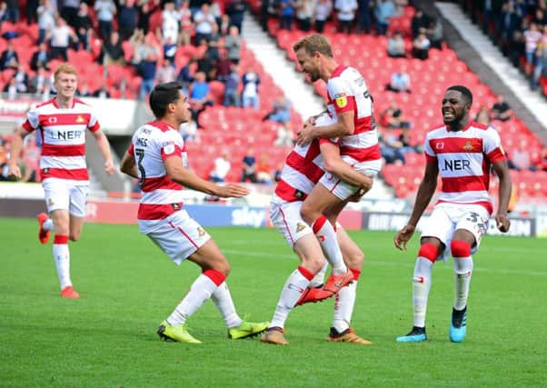 Doncaster Rovers James Coppinger and team-mates celebrate their winning goal against Fleetwood (Picture: Marie Caley).