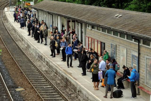 Commuters at Horsforth wait for a rush-hour train.