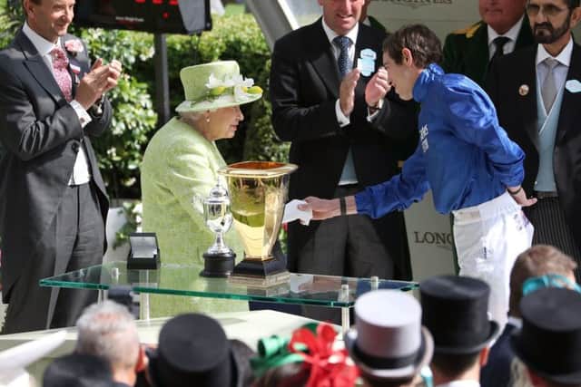 James Doyle collects his prize from the Queen after Blue Point won the Diamond Jubilee Stakes at Royal Ascot.