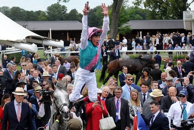 Frankie Dettori celebrates Logician's win in the Great Voltigeur Stakes.