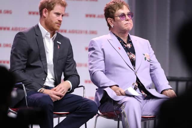 File photo dated 24/7/2018 of the Duke of Sussex with Sir Elton John during the Aids 2018 summit in Amsterdam, the Netherlands. Sir Elton has said he provided the Duke and Duchess of Sussex with a private jet flight to his home in Nice to give the royal couple a "high level of much-needed protection".