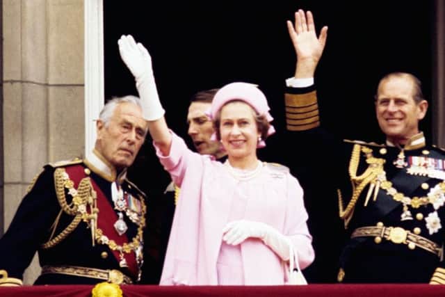 File photo dated 07/06/77 (left to right) Earl Mountbatten of Burma, Queen Elizabeth II and the Duke of Edinburgh wave from the balcony of Buckingham Palace after the Silver Jubilee procession.