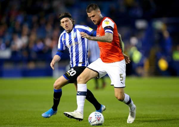 Sheffield Wednesday's Adam Reach (left) and Luton Town's Sonny Bradley battle for the ball.