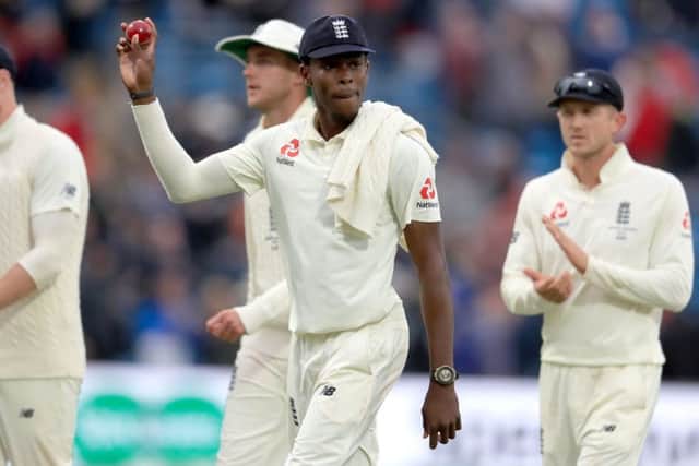 England's Jofra Archer holds the ball up after taking six wickets.