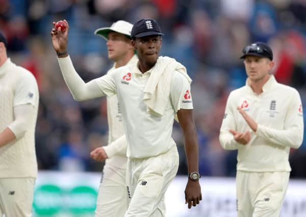England's Jofra Archer holds the ball up after taking six wickets.