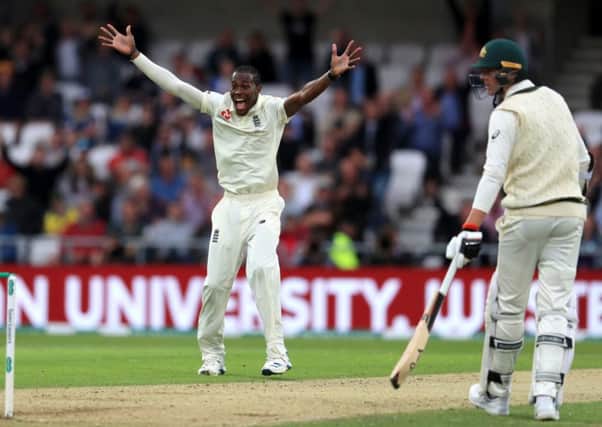 England's Jofra Archer celebrates taking the wicket of Australia's Nathan Lyon.