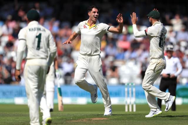 ON YOUR WAY: Australia's Pat Cummins celebrates the wicket of England's Chris Woakes on day two at Headingley. Picture: Mike Egerton/PA
