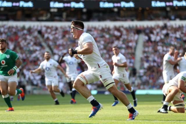 England's Tom Curry (centre) celebrates scoring his side's fifth try against Ireland at Twickenham. Picture: David Davies/PA